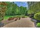 Inviting backyard patio with garden boxes and access to a lush green lawn at 2001 Arundale Ln, Matthews, NC 28104