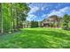 Expansive backyard with lush green lawn and mature trees, perfect for outdoor activities at 2001 Arundale Ln, Matthews, NC 28104
