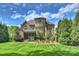 A well-maintained lawn complements the elegant brick exterior and screened porch of this stunning home at 2001 Arundale Ln, Matthews, NC 28104
