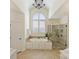 Luxurious bathroom featuring a soaking tub under a large window and a separate glass shower at 2001 Arundale Ln, Matthews, NC 28104