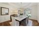Elegant dining room featuring a marble table, modern chandelier, and large window with decorative shutters at 2001 Arundale Ln, Matthews, NC 28104