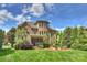 Stately brick home showcases a charming screened porch, manicured landscaping, and a serene outdoor setting at 2001 Arundale Ln, Matthews, NC 28104