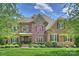 Charming brick and stone home featuring manicured lawn and lush landscaping in a sought-after neighborhood at 2001 Arundale Ln, Matthews, NC 28104
