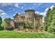 The home's brick exterior, screened porch, and lush landscaping create an inviting outdoor living space at 2001 Arundale Ln, Matthews, NC 28104