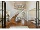 Bright foyer showcasing a grand staircase with hardwood floors and elegant architectural details at 2001 Arundale Ln, Matthews, NC 28104