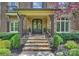 Charming home featuring a stone walkway leading to a covered porch with double doors and manicured landscaping at 2001 Arundale Ln, Matthews, NC 28104