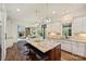 Open kitchen with a large island, granite countertops, stainless appliances, and hardwood floors at 2001 Arundale Ln, Matthews, NC 28104