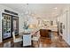 Spacious kitchen with white cabinets, a large island, modern appliances, and a breakfast nook with French doors at 2001 Arundale Ln, Matthews, NC 28104