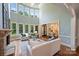 Bright living room with high ceilings, fireplace, and a view into the kitchen and dining area at 2001 Arundale Ln, Matthews, NC 28104