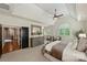 Spacious main bedroom featuring tray ceilings, carpet floors, a large dresser, and an arched window at 2001 Arundale Ln, Matthews, NC 28104