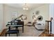 Charming piano room featuring a grand piano, comfortable seating, and elegant decor at 2001 Arundale Ln, Matthews, NC 28104