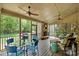 Relax on the screened porch with a stone fireplace, ceiling fans, and views of the backyard at 2001 Arundale Ln, Matthews, NC 28104