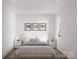Minimal bedroom features a plush bed, modern decor, and a cozy rug at 2011 Sadler Woods Ln, Charlotte, NC 28214