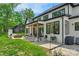 Exterior showcasing a lush backyard with a covered patio and architectural details at 2165 Country Club Rd, Lincolnton, NC 28092