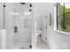 Sleek bathroom featuring a glass-enclosed shower with marble tile and brass fixtures at 2165 Country Club Rd, Lincolnton, NC 28092