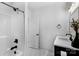 Modern bathroom with shower and vanity with black fixtures and white cabinets at 2165 Country Club Rd, Lincolnton, NC 28092