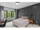 Modern bedroom with a paneled accent wall, ample natural light, and neutral decor at 2165 Country Club Rd, Lincolnton, NC 28092