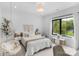 Bright bedroom featuring a hanging chair, large window, and neutral decor at 2165 Country Club Rd, Lincolnton, NC 28092