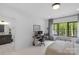 Bright bedroom featuring an office area, en suite bathroom, and wooded views at 2165 Country Club Rd, Lincolnton, NC 28092