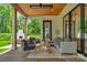 Relaxing covered patio with comfortable seating, a ceiling fan, and a view of the backyard and outdoor fireplace at 2165 Country Club Rd, Lincolnton, NC 28092