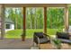 Inviting covered patio with wood columns, comfortable seating, and a view of the expansive backyard at 2165 Country Club Rd, Lincolnton, NC 28092