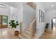 Open entryway with wooden staircase, hardwood floors, and black handrails for a modern and inviting feel at 2165 Country Club Rd, Lincolnton, NC 28092