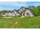 Beautiful two-story home with a lush green lawn, tidy landscaping, and a welcoming entrance at 2165 Country Club Rd, Lincolnton, NC 28092