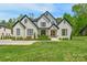 Stunning two-story brick home boasts black trim, a manicured lawn, and meticulous landscaping at 2165 Country Club Rd, Lincolnton, NC 28092