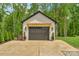 Detached garage with a modern design, a pergola, and mature landscaping, offering ample parking and storage space at 2165 Country Club Rd, Lincolnton, NC 28092