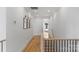 Hallway with light wood floors leading to an adjacent room with a window at 2165 Country Club Rd, Lincolnton, NC 28092