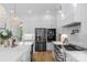 Modern kitchen with white cabinets, stainless steel appliances, and a stylish pendant light fixture at 2165 Country Club Rd, Lincolnton, NC 28092