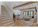 Bright, open living room features wood floors, a neutral sectional sofa, and a modern chandelier at 2165 Country Club Rd, Lincolnton, NC 28092