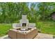 Inviting outdoor fireplace with a seating area, perfect for entertaining and enjoying the backyard view at 2165 Country Club Rd, Lincolnton, NC 28092