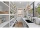 Walk-in pantry with custom shelving, natural light, and a sink for added convenience at 2165 Country Club Rd, Lincolnton, NC 28092