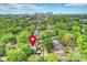 Aerial view of a home in a leafy neighborhood with a skyline in the background at 2229 Kenmore Ave, Charlotte, NC 28204