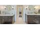 Bright bathroom with dual sinks, dark cabinets, white countertops, and modern fixtures at 2229 Kenmore Ave, Charlotte, NC 28204
