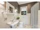 Stylish bathroom with subway tile, vintage style fixtures, and a bright window with a view at 2229 Kenmore Ave, Charlotte, NC 28204