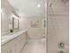 Bright bathroom featuring dual sinks, modern lighting, and a subway-tiled shower with chrome fixtures at 2229 Kenmore Ave, Charlotte, NC 28204