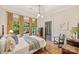 Comfortable bedroom featuring hardwood floors, large window views, and neutral color palette at 2229 Kenmore Ave, Charlotte, NC 28204