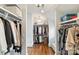 Well-organized walk-in closet with wooden floors, white shelving, and ample hanging space at 2229 Kenmore Ave, Charlotte, NC 28204