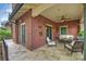 Covered front porch with tiled flooring, comfortable seating, and ceiling fan, providing a welcoming and relaxing outdoor space at 2229 Kenmore Ave, Charlotte, NC 28204