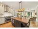 Gourmet kitchen with professional grade appliances and island overlooking living area at 2229 Kenmore Ave, Charlotte, NC 28204