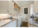 Functional laundry room with sink, granite counters, washer and dryer, and ample storage space at 2229 Kenmore Ave, Charlotte, NC 28204