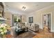 Spacious living room with hardwood floors, a comfortable sofa, and ample natural light, perfect for relaxing and entertaining guests at 2229 Kenmore Ave, Charlotte, NC 28204