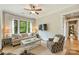 Comfortable living room with decorative armchairs, a ceiling fan, and large windows at 2229 Kenmore Ave, Charlotte, NC 28204