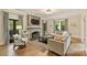 Elegant living room featuring a fireplace, hardwood floors, and large windows, offering a comfortable and stylish living space at 2229 Kenmore Ave, Charlotte, NC 28204