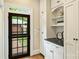 Convenient mud room off the kitchen, featuring cabinetry, and direct access to the outside at 2229 Kenmore Ave, Charlotte, NC 28204