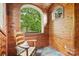 Cozy sitting area featuring wood-paneled walls, arched windows, and a comfortable chair at 2229 Kenmore Ave, Charlotte, NC 28204