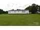 Expansive backyard features well-maintained lawn and a view of the home's rear exterior at 234 Olin Loop, Olin, NC 28660