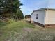 A serene backyard view featuring a wooden deck and lush greenery at 234 Olin Loop, Olin, NC 28660